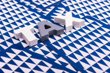 Tax time concept: Word TAX on blue and white triangle pattern background.