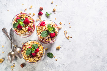 Fototapeta na wymiar Yogurt parfafait with granola and raspberries top view.