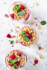 Yogurt parfafait with granola and raspberries top view.