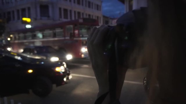 Girl photographing traffic at night in Kandy, Sri Lanka