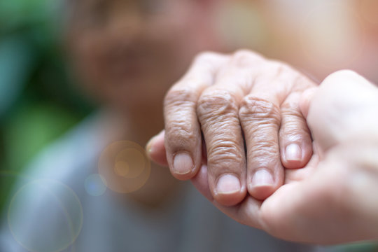 Caregiver, Carer Hand Holding Elder Hand Woman In Hospice Care. Philanthropy Kindness To Disabled Concept.Public Service Recognition Week