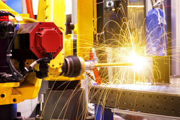 Motion Welding robots in factory with sparks, manufacturing, industry, factory