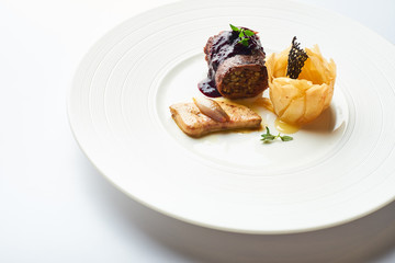black pudding on a white plate in a restaurant