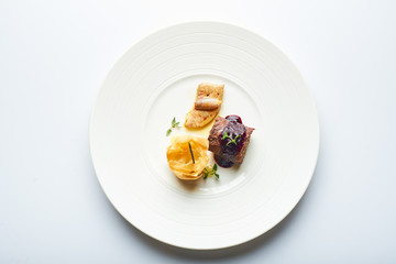 black pudding on a white plate in a restaurant