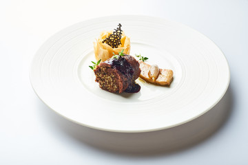 black pudding on a white plate in a restaurant