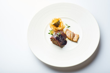 black pudding on a white plate in a restaurant