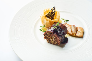 black pudding on a white plate in a restaurant