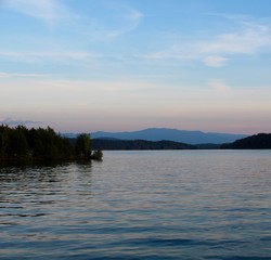The sunset at the lake with the mountain range in horizon.