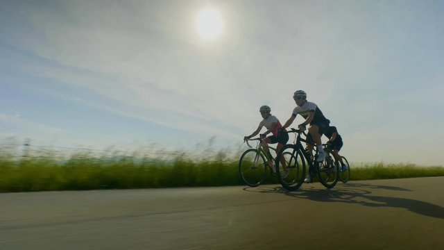 Low angle, tracking shot of group of cyclists