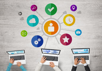 Top view of businesspeople sitting at table and using gadgets