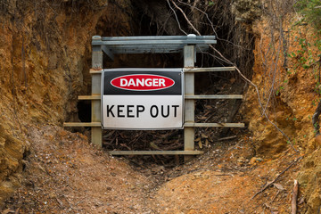 Danger Keep Out safety warning sign in front of closed gold mine Jupiter Diggings in Adelaide Hills South Australia