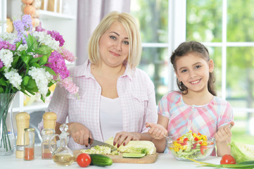 mother and daughter cooking together