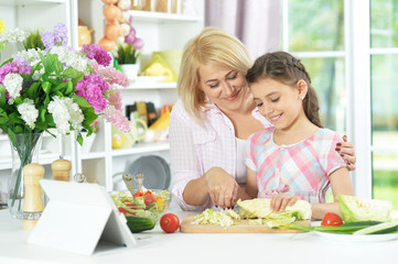 mother and daughter cooking together