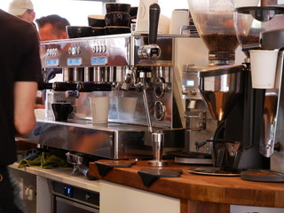 Barista Setup Behind the Scenes with Espresso Machine and Cups of Coffee
