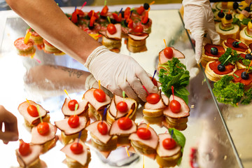 The waiter puts desserts on a buffet table