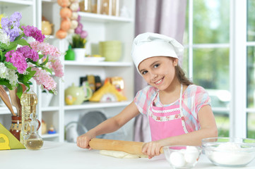 Cute little girl making dinner
