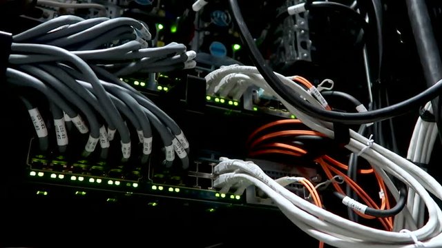 LED port status is blink. Network gigabit switch for high speed network in data center room. RJ45 jacks blinking LED lights. Close up. 4K