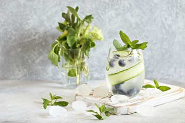 Cold Infused Water with Cucumber and Blueberry. Trend Summer Iced Drinks. Season Beverages.