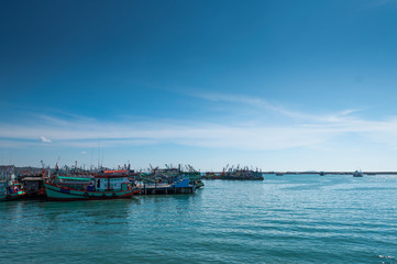 Seascape images , Vivid fresh bright colorful, Beautiful nature of whithe clouds on blue sky And Mane fishing boats are parked at the shore, This place is Ragyong Sea in Thailand