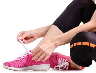 Female legs sports leggings sneakers sports exercises on a white background isolation