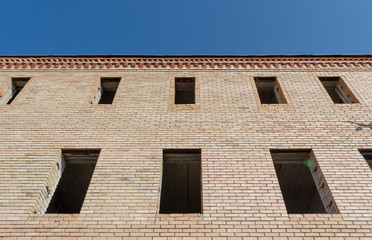 unfinished building with Windows on the background of the blue sky