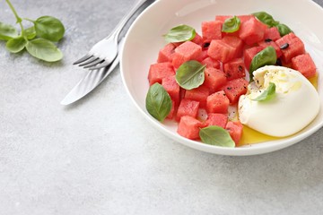Watermelon Mozzarella Salad with basil and olive oil. Selective focus