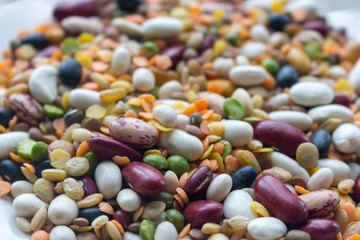 Mix of beans, peas, mung, lentil and kidney beans closeup. Organic healthy food. Vegeterian food concept. Mixed beans in perspective. Protein meal. Agriculture background.