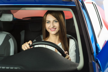 Woman sits behinde the wheel