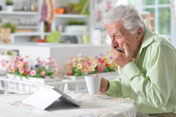 man  using digital tablet