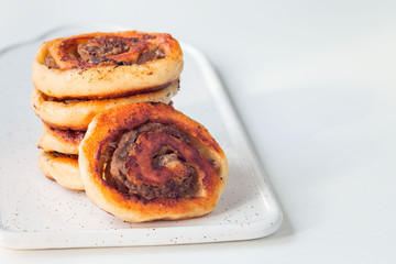 Fried savoury cottage cheese pies with minced meat on white plate, served with yogurt, horizontal, copy space