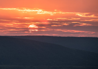 Dramatic sky during sunset over Volga river in front of hills near Samara city, Russia