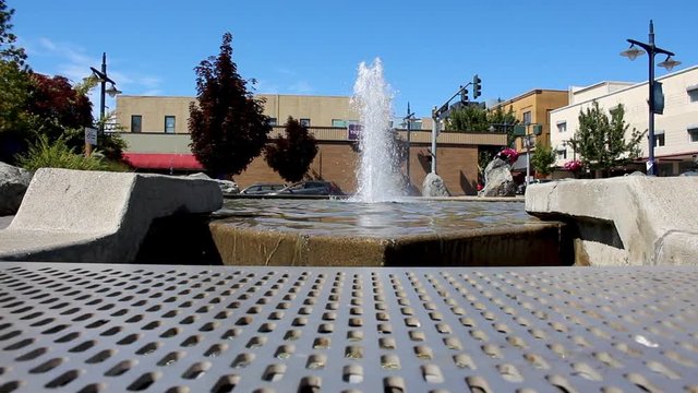 Urban water park with water fountain trees and blue sky shot in summer or spring 1920 x 1080 24 frp