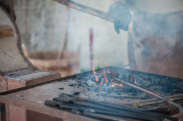 Coal ignition. Blacksmiths coals burning for iron work. The Medieval Days in Tallinn Old Town.