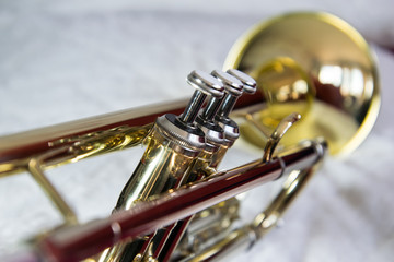 Obraz na płótnie Canvas Trumpet, brass close up, focus on valves, the bell is blurry, positioned diagonally, bell on the right