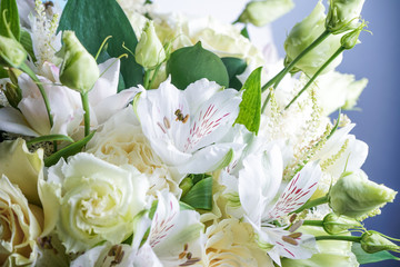 beautiful wedding bouquet with white roses and other flowers on wooden background  with 2 wooden pigeons