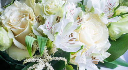beautiful wedding bouquet with white roses and other flowers on wooden background  with 2 wooden pigeons