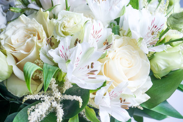 beautiful wedding bouquet with white roses and other flowers on wooden background  with 2 wooden pigeons