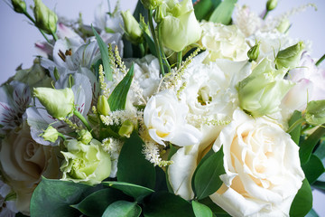 beautiful wedding bouquet with white roses and other flowers on wooden background  with 2 wooden pigeons