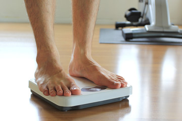 Male on the weight scale for check weight, Diet concept
