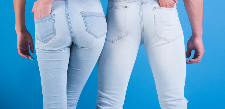 Jeans Fashion Always Fashionable. Man And Woman In White Jeans On Blue Background. Beautiful Jeans Emphasize Shapes. Jeans It For Everyone, Of Any Age, Always In Style. Couple In Love Holding An Ass