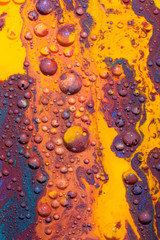 Mars-like landscape created with several paints on Glycerine which are forming little colorful balls and isles