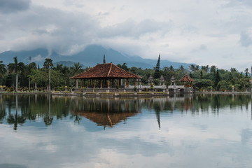 Fototapeta na wymiar Bali, Indonesia: Panoramic view of building on lake shore with reflection in water