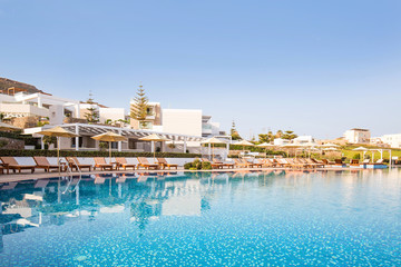 Fototapeta na wymiar Hotel swimming pool, outdoor, with sunbeds around