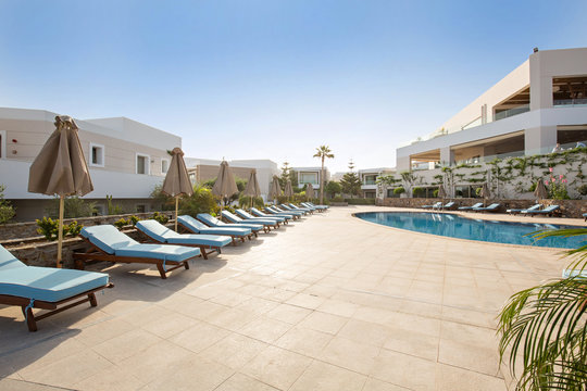 Hotel swimming pool, outdoor, with sunbeds around