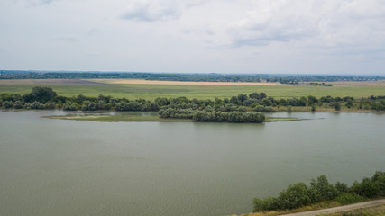 Russian forest, river, roads under blue sky by aerial drone. Stunning Aerial Drone Stock Photo of South russian forest, river, roads.