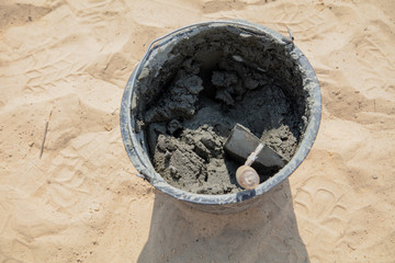 The worker mixes the concrete mixture at the construction site