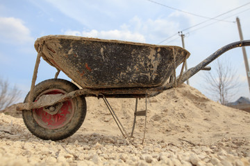 Wheelbarrow for mortar at the construction site