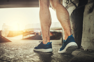 Close up of male feet in motion. Muscular guy is training in snickers to stay fit