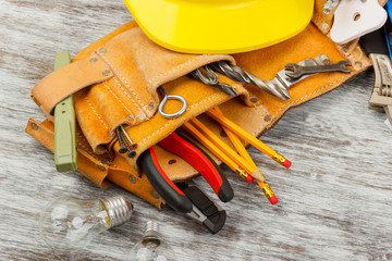 Different construction tools, wooden background