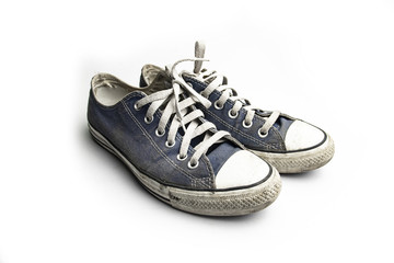 Dirty trainer canvas shoes on white background